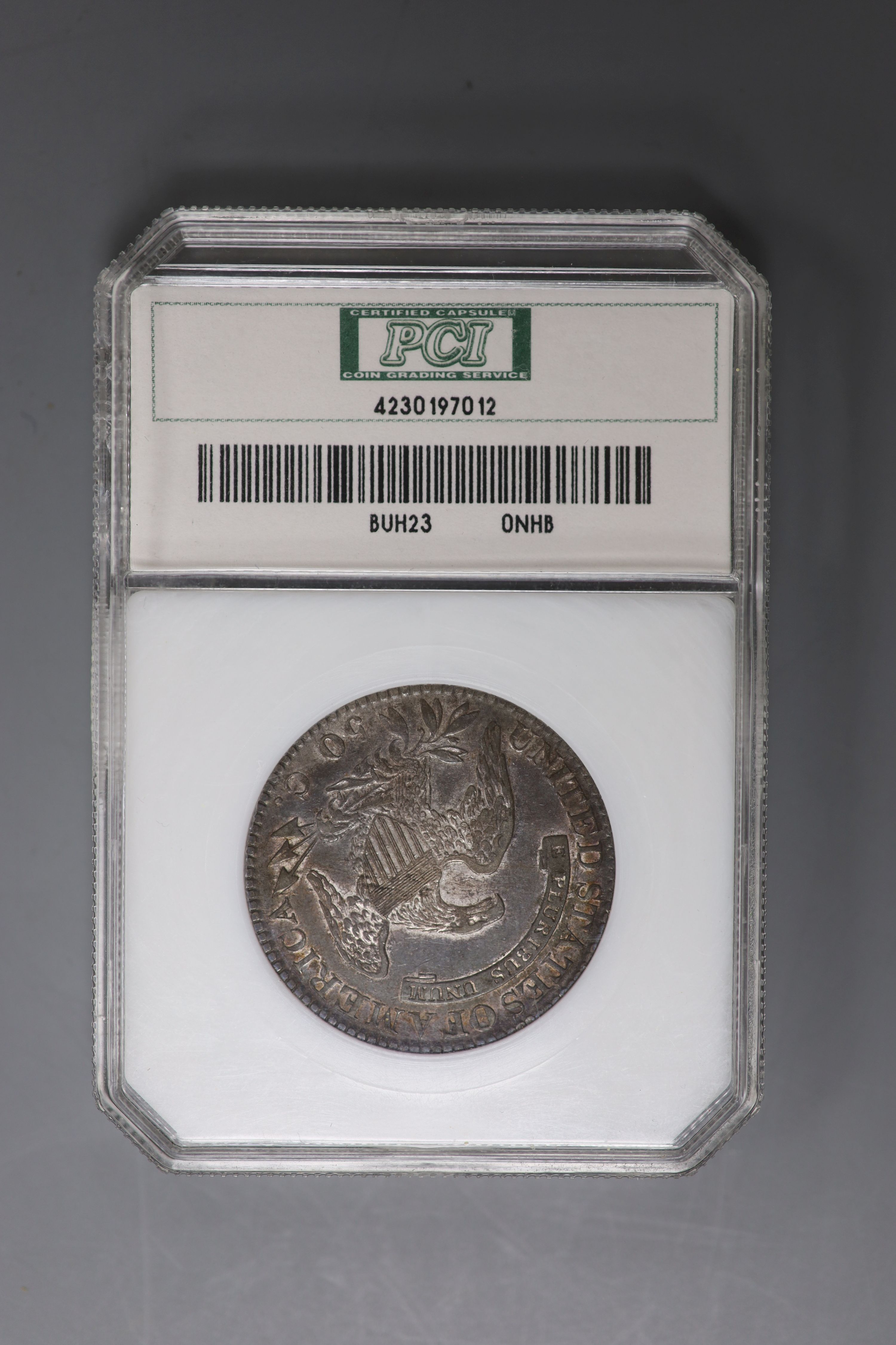 A U.S. capped bust 50 cents, 1823, graded by PCI as planchet Flaw EF45